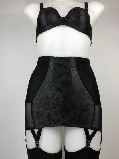 Black floral shapewear lingerie. 1950s and 1940s vintage inspired underwear by in the UK. Shaping six strap long line girdle, girdlette perfect for holding seamed nylon stockings in place. Bettie page inspired retro fetish black clematis patterned underwired bra with sheer mesh panel, classic cut panties knickers. Elegant timeless feminine underwear and lingerie custom made to order in the UK