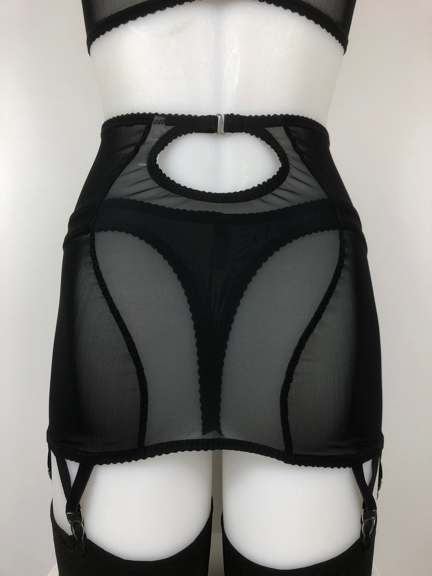 Sheer see through black mesh thong. Transparent fetish bettie page pin up inspired lingerie underwear. Girdlette, soft bra and underwired corselette also available