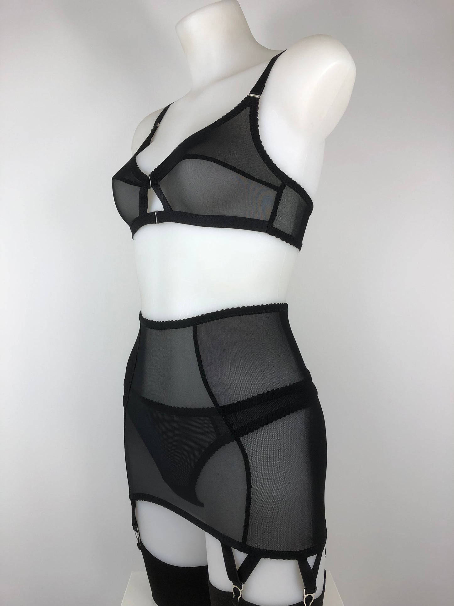 Sheer see through black mesh longline girdle with 6 suspender straps. Transparent fetish bettie page inspired lingerie underwear. Girdlette and corselette also available